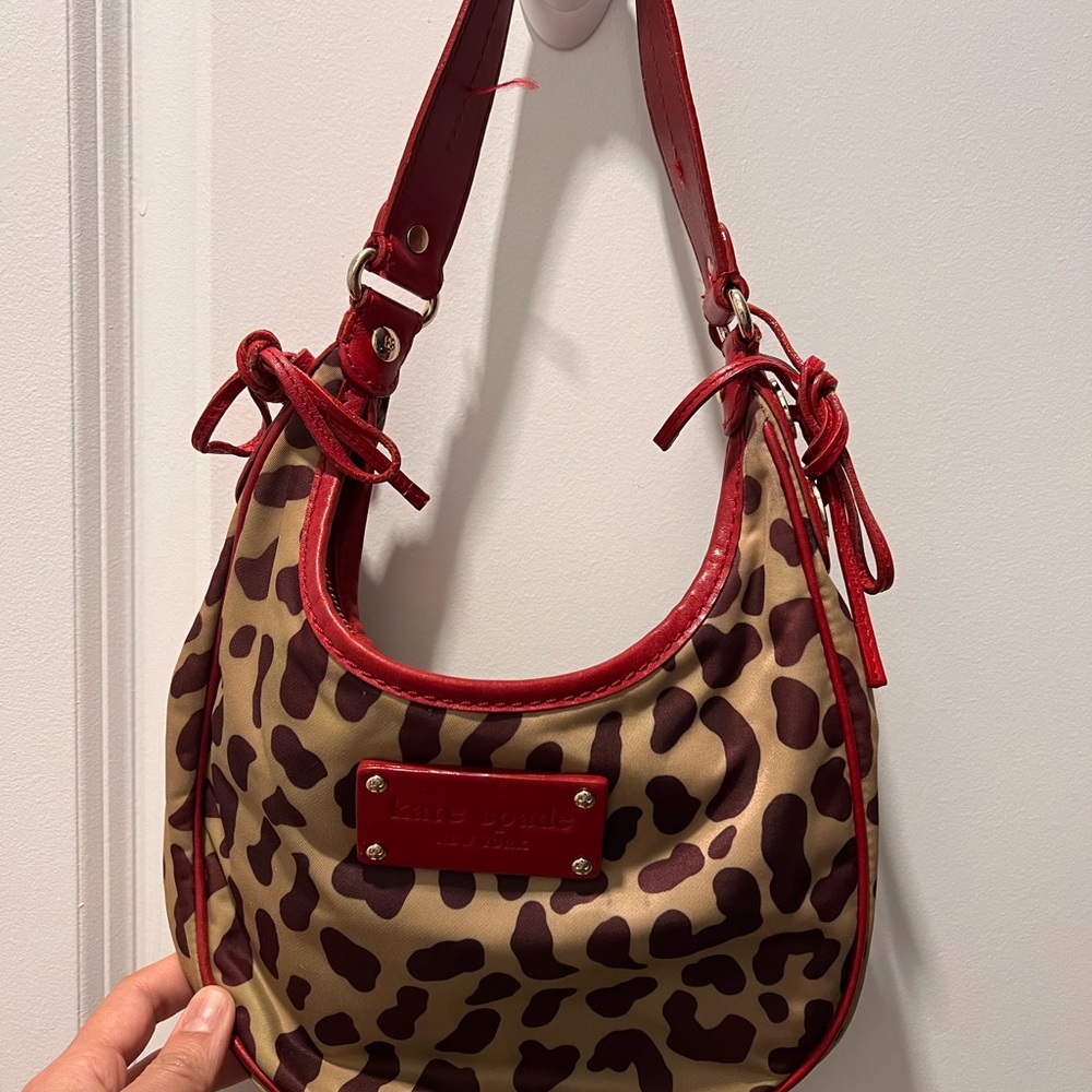 Stylish vintage Kate Spade Leopard Print Hobo Bag with Red Accents.